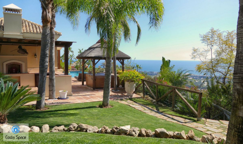 View of the barbecue house, Jacuzzi and swimming pool, with the sea views in the backdrop